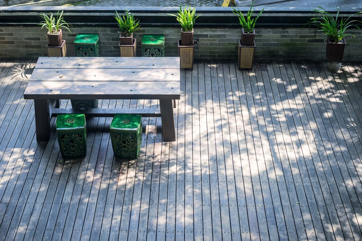 terrace-with-wooden-table-plants-min